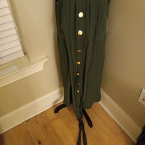 Women's olive green dress with gold buttons.